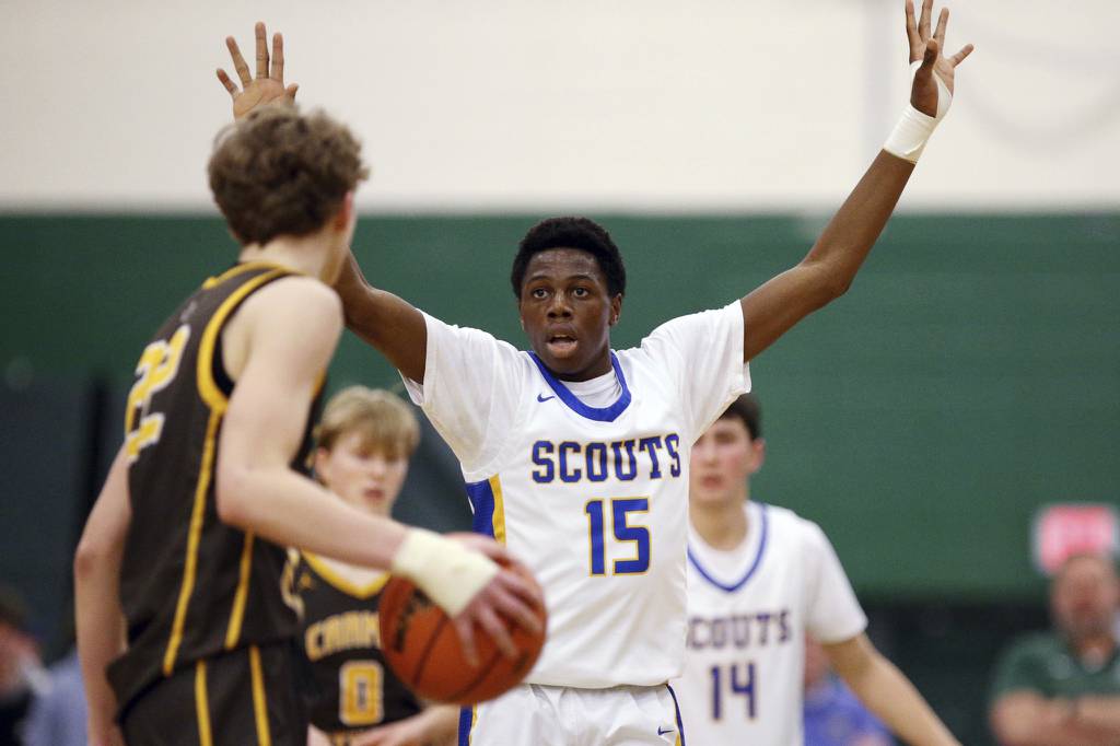 Lake Forest’s Bolurin Taiwo (15) guards Carmel’s James Dwyer (22) during a Class 3A Grayslake Central Sectional semifinal on Tuesday, Feb. 28, 2023.