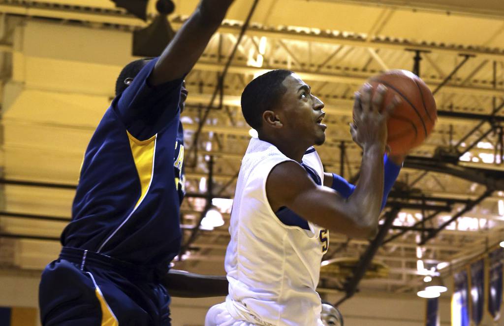 Simeon's Bobby Harris maneuvers under the basket against Chicago Vocational in a Chicago Public League game on Jan. 14, 2013.