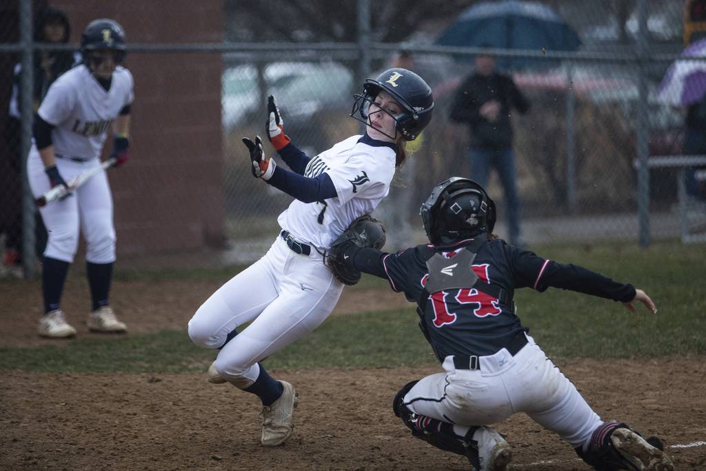 Marist’s Caroline O'Brien (14) tags Lemont’s Nicole Pontrelli (7) at the plate during a nonconference game in Chicago on Wednesday, March 22, 2023.