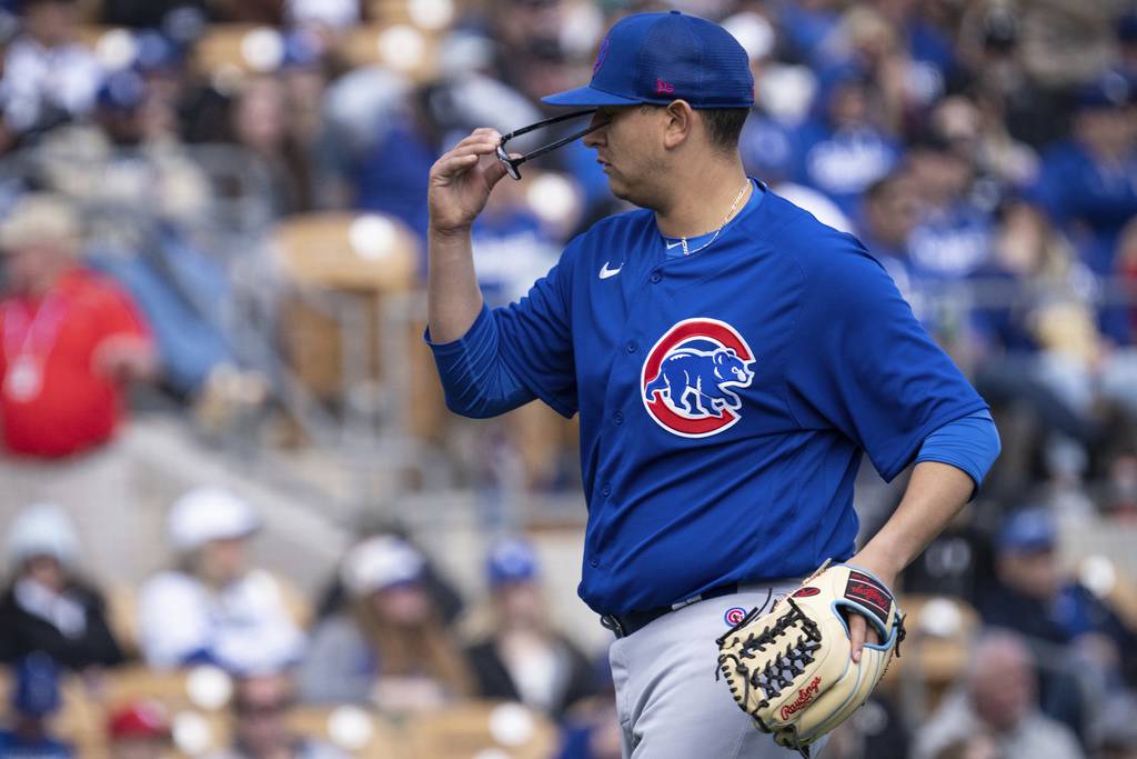 Starting pitcher Javier Assad removes his glasses after retiring the side in the third inning of the Cubs’ 9-4 loss to the Dodgers on Feb. 26, 2023, at Camelback Ranch in Glendale, Ariz.