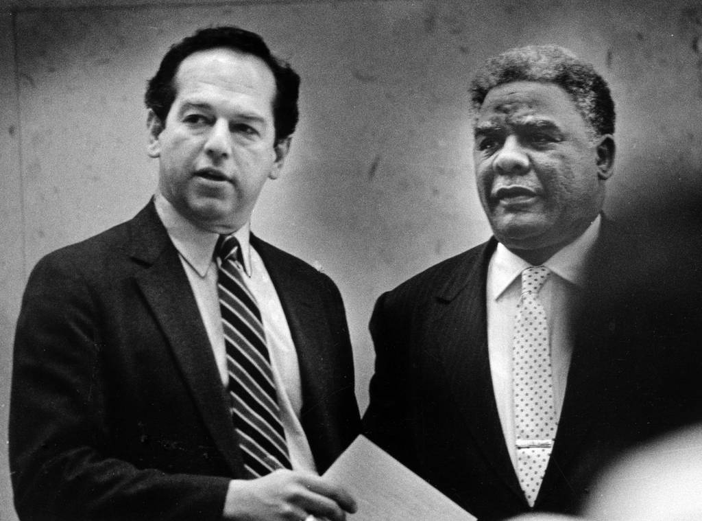 Ald. Martin Oberman, 43rd, left, talks with Chicago Mayor Harold Washington during a City Council meeting on March 18, 1987. 
