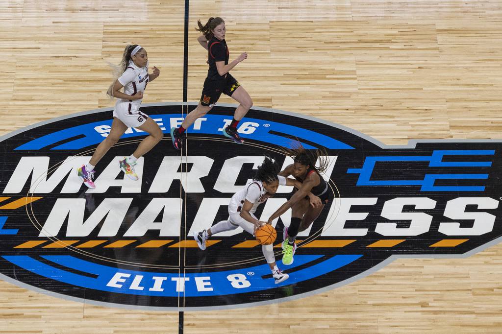 South Carolina's Zia Cooke dribbles while Maryland's Diamond Miller, at bottom right, defends in the first half of an Elite Eight game of the NCAA Tournament in Greenville, South Carolina, on Monday.