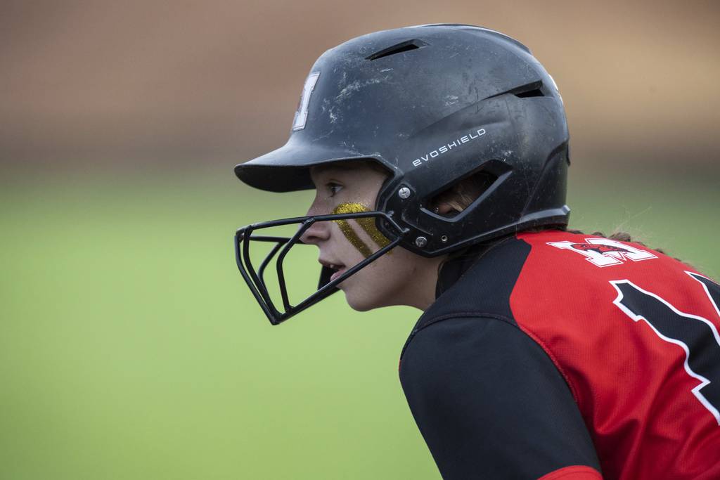 Marist’s Caroline O'Brien (14) looks for a chance to run while on base against Evergreen Park during a nonconference game in Evergreen Park on Thursday, March 23, 2023.