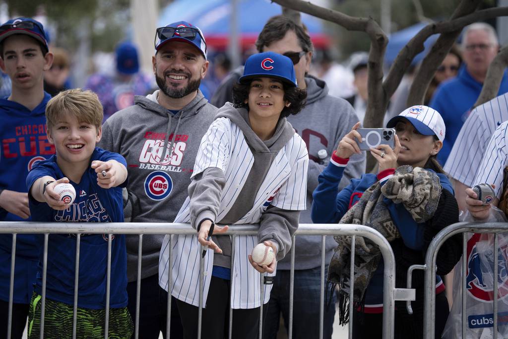 Matthew Maldonado, 13, center, looks for autographs with his father Anibal Maldonado outside Sloan Field in Mesa, Arizona on Feb. 25, 2023. 