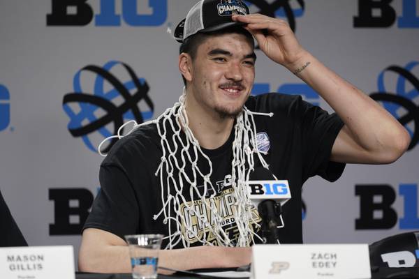 Purdue's Zach Edey wears the net around his neck after his team's 67-65 win over Penn State to claim the Big Ten championship on March 12, 2023.