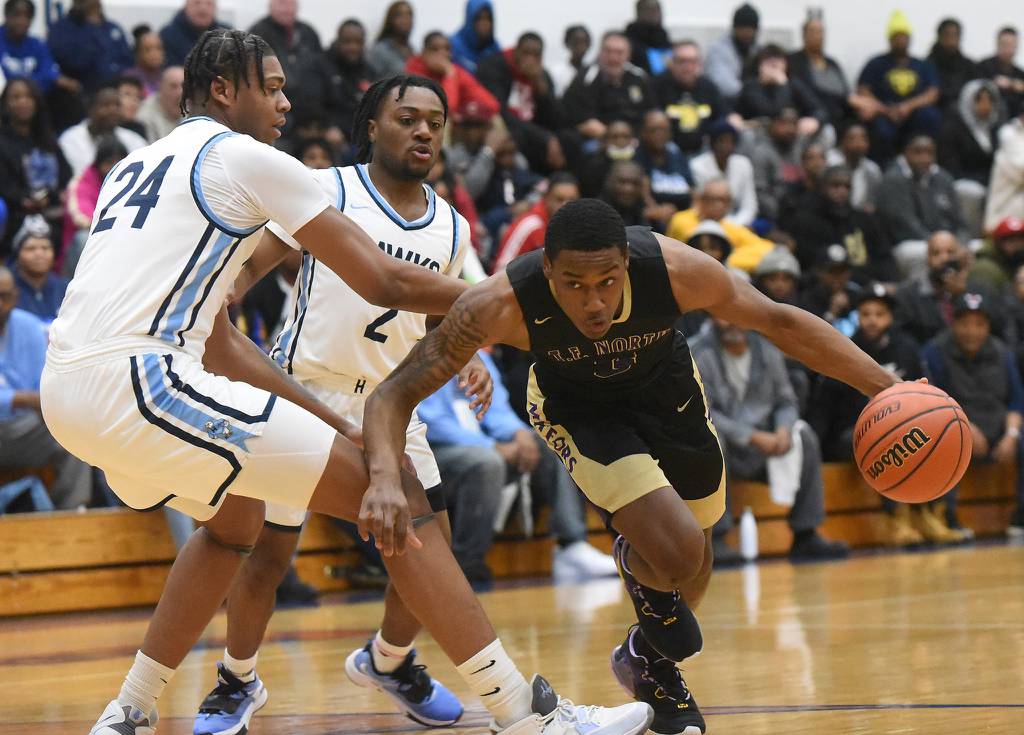 T.F. North's Jevon Warren (3) tries to work past Hillcrest's Darrion Baker (24) during the Class 3A Hillcrest Sectional semifinals in Country Clubs Hills on Tuesday, Feb. 28, 2023.