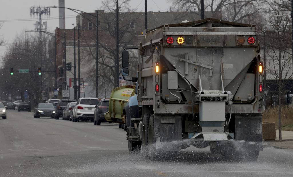 A Streets and Sanitation salt spreader passes along the 2100 block of West Harrison Street in Chicago, in preparation for an expected snowstorm on Dec. 22, 2022.  