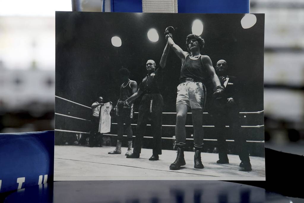 A photo showing Joe Birkett raising his arm after beating Edwin Santiago during the 1974 Chicago Golden Gloves light heavyweight Championship at the Northwest Armory, is propped up against the ring at Cicero Stadium on March 28, 2023.