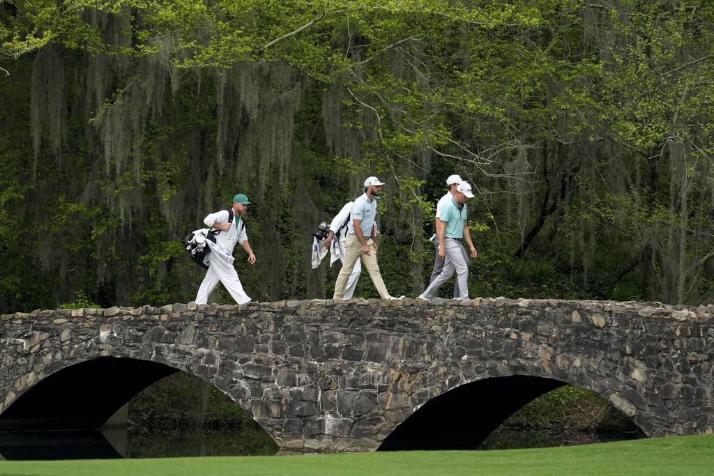 Justin Thomas, Max Homa and Gordon Sargent walks across the bridge on the 13th hole during a practice for the Masters at Augusta National Golf Club on April 3, 2023.