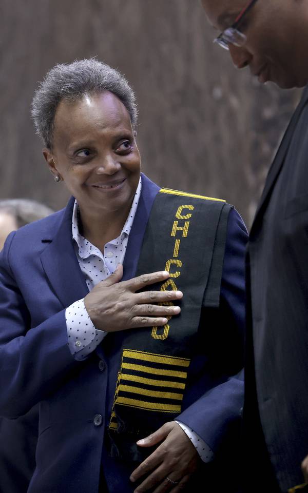 Outgoing Mayor Lori Lightfoot is presented with a black Chicago shoulder cloth by Ald. Jason Ervin, 28th, during what is expected to be the last City Council meeting of her term on April 19, 2023.