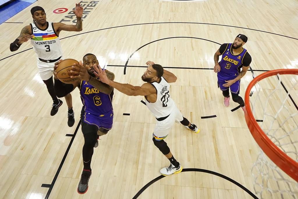 Lakers forward LeBron James (6) goes up for a shot against Timberwolves center Rudy Gobert during the first half of a game on March 31, 2023.