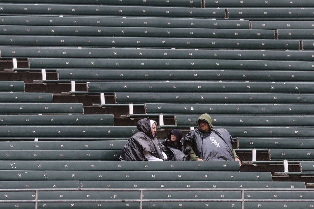 Fans sit in the rain waiting for the White Sox-Orioles game to begin on April 16 at Guaranteed Rate Field. 