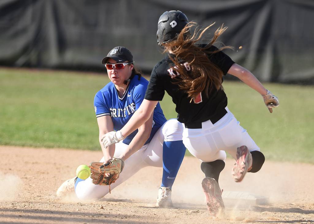 Lincoln-Way East shortstop Katie Stewart (20) tries to come up with the throw as Lincoln-Way Central's Kendall Pearson (7) steals second base during a SouthWest Suburban Conference crossover in Frankfort on Tuesday, April 11, 2023.