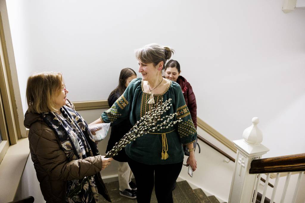 Iryna Ryvak, left, touches Bohdana Stasiv with a pussy willow during a Palm Sunday service at St. Nicholas Ukrainian Catholic Cathedral in Chicago on April 2, 2023.