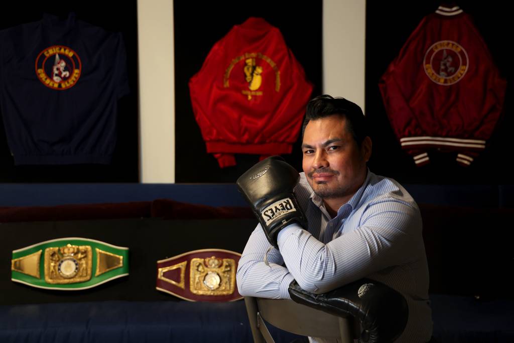 Jorge Pacheco sits surrounded by some of his Chicago Golden Gloves jackets and belts at his Apache business office in the South Loop, April 5, 2023. 