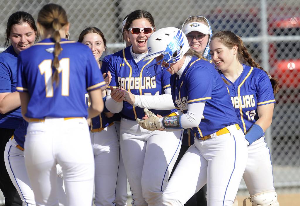 Sandburg's Zoe Jeanes (8) gets greeted at home after hitting a home run against Homewood-Flossmoor during a SouthWest Suburban Blue game in Orland Park on Tuesday, April 18, 2023.