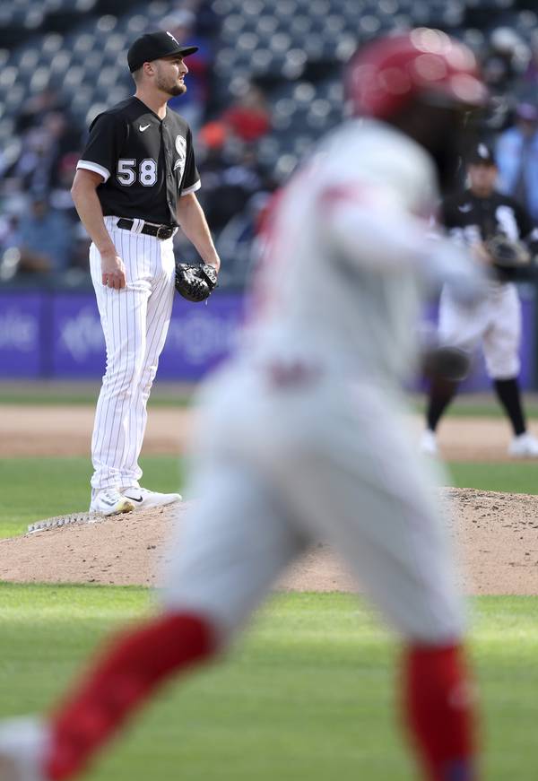 White Sox reliever Jimmy Lambert (58) stands on the mound as Phillies third baseman Josh Harrison, foreground, rounds the bases after hitting a two-run home run in the seventh inning of Game 1 of a doubleheader on Tuesday, April 18, 2023, at Guaranteed Rate Field.