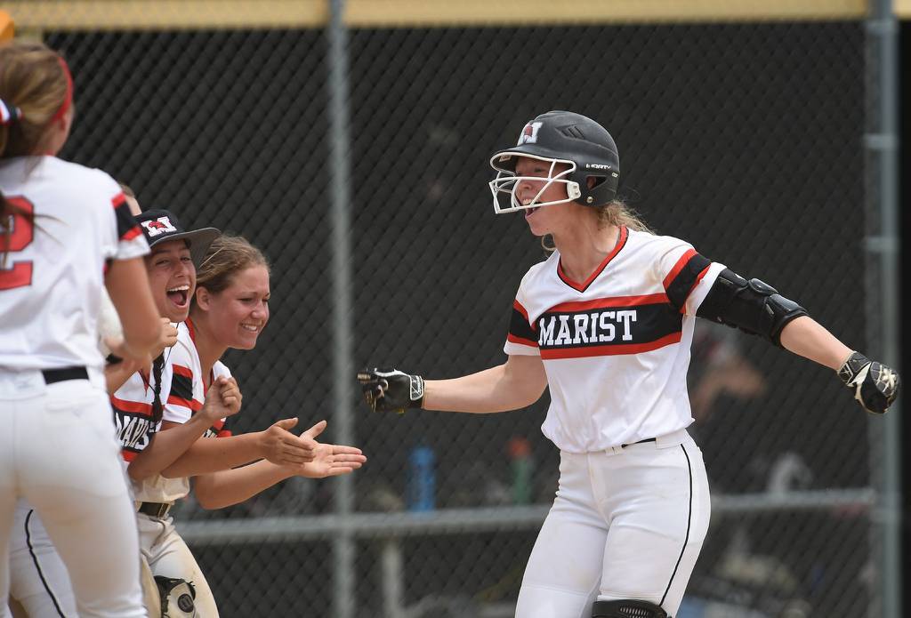 Marist's Angela Zedak (9) celebrates after hitting a home run against Sandburg during a Class 4A sectional game on Saturday, June 2, 2018.