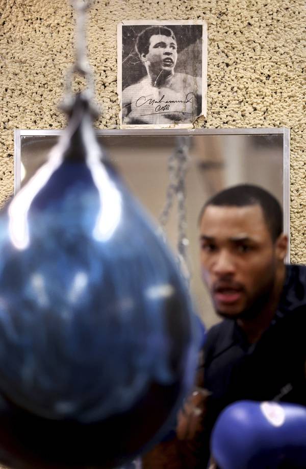 Eric Ross trains in front of an image of Muhammad Ali at Trumbull Park in Chicago’s South Deering neighborhood on April 5, 2023.  Ross is currently seeking his third championship in the Chicago Golden Gloves boxing tournament.  