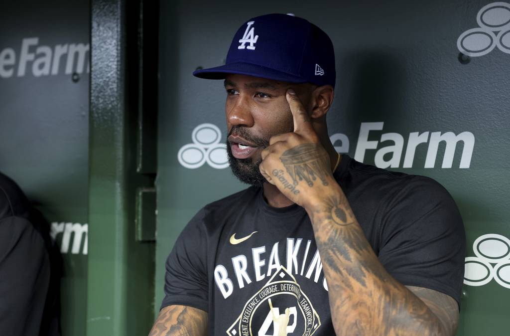 Dodgers outfielder Jason Heyward chats with reporters in the dugout before the start of a game against the Cubs on Thursday at Wrigley Field. Heyward played for the Cubs from 2016-22. 