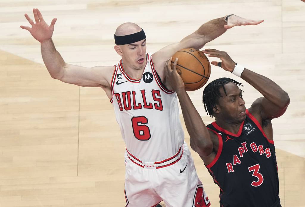 Raptors forward O.G. Anunoby, right, loses the ball to Bulls guard Alex Caruso during the first half a play-in game Wednesday in Toronto. 