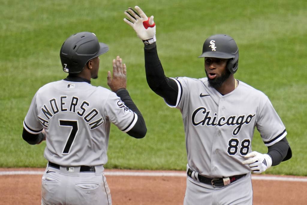 White Sox center fielder Luis Robert Jr. (88) is greeted by Tim Anderson at the plate after hitting a two-run home run against the Pirates in the third inning Friday in Pittsburgh. 