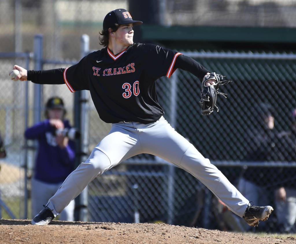 St. Charles East's Alex Bennett (30) delivers a pitch in relief against Waubonsie Valley during a game in Aurora on Monday, March 27, 2023.