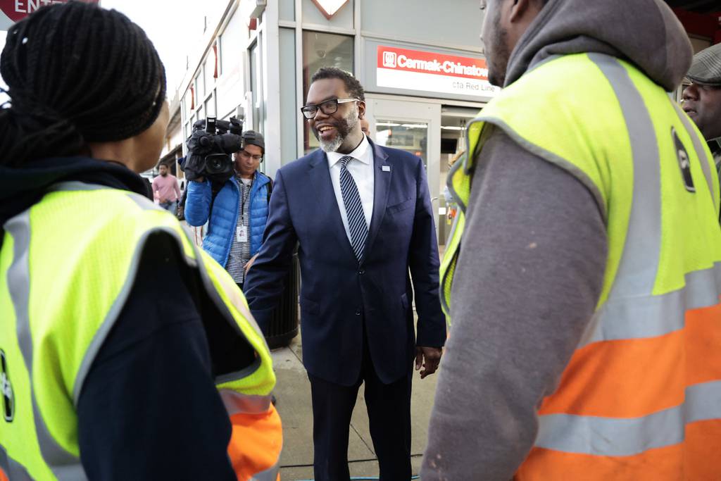 Mayor-elect Brandon Johnson is greeted warmly by people outside the Chinatown CTA train station in Chicago on April 5, 2023, following Johnson’s runoff election victory over Paul Vallas.