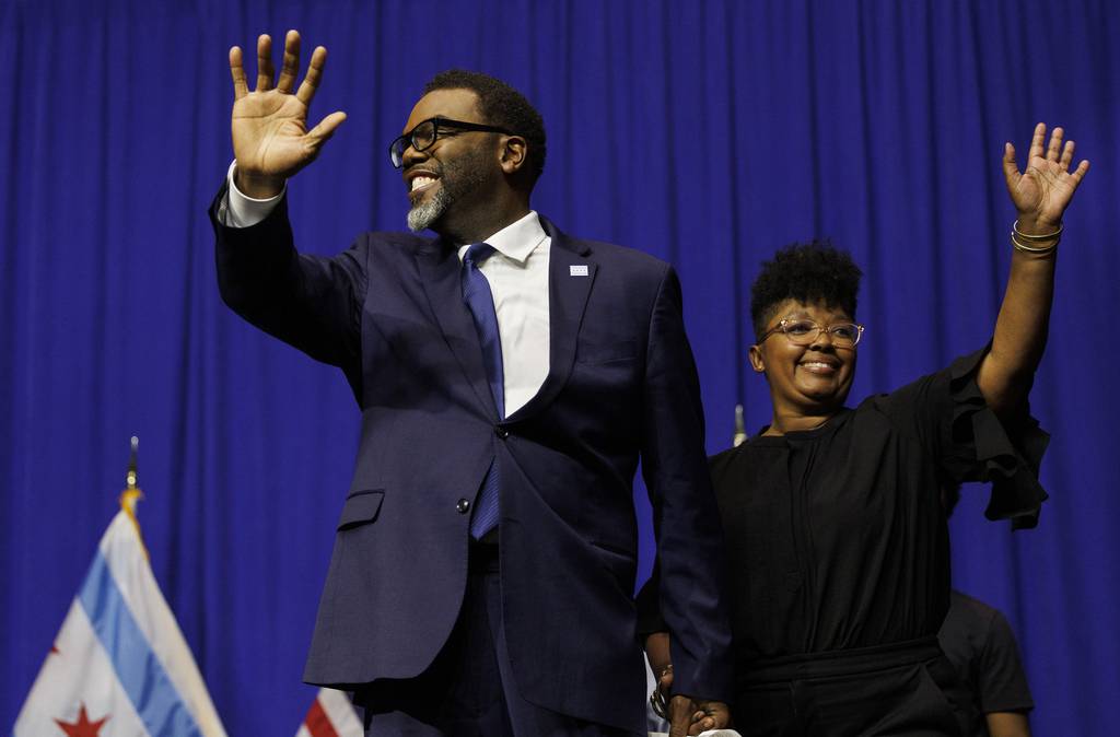Brandon Johnson walks on stage with his wife, Stacie Rencher-Johnson, and children Owen, Ethan and Braedyn at his victory party on election night on April 4, 2023. 