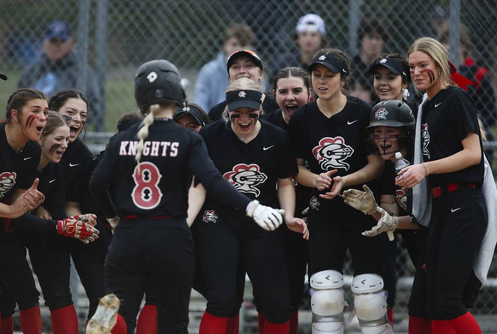 Lincoln-Way Central's players crowd around home plate as Sarah Kmak (8) rounds the bases after hitting a home run in the sixth inning against Marist during a nonconference game in New Lenox on Monday, April 3, 2023.