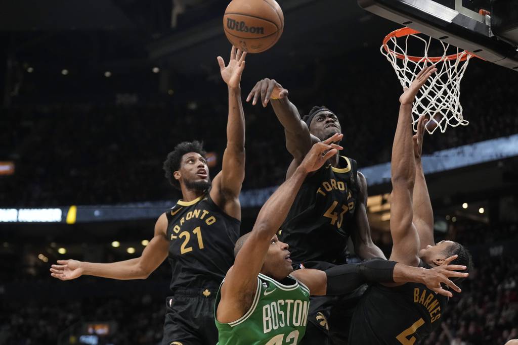 Raptors forward Pascal Siakam (43) blocks a shot by Celtics center Al Horford as Thaddeus Young (21) and Scottie Barnes (4) help defend on Jan. 21, 2023, in Toronto.