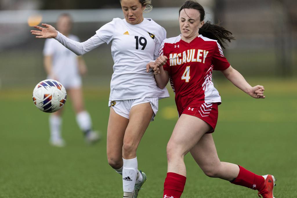 Mother McAuley's Annemarie Clark (4) and Andrew’s Paige Swaw (19) go after a ball during a nonconference game in Chicago on Monday, April 3, 2023.