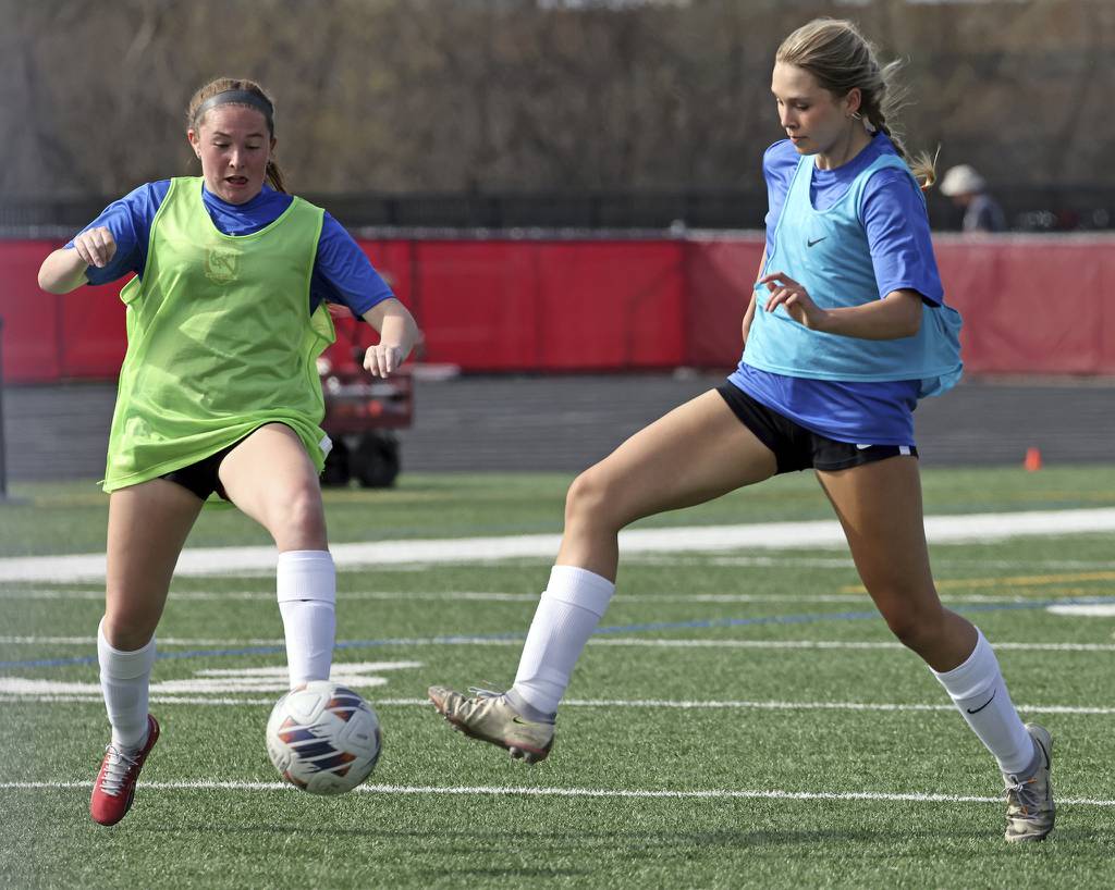 Barrington’s Annie Tarpey, left, and Brooke Brown go for the ball during a practice on campus on Friday, April 14, 2023. 
