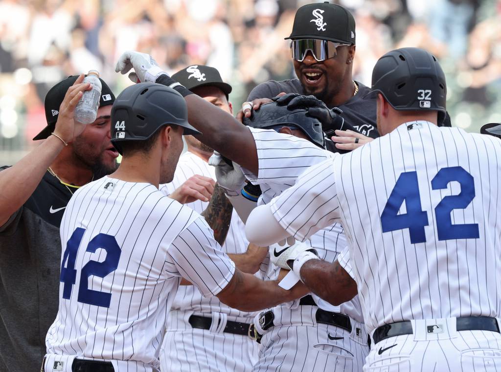 Right fielder Oscar Colás, center, is congratulated after driving in the winning run in the 10th inning, giving the White Sox a 7-6 victory against the Orioles on Saturday at Guaranteed Rate Field. 