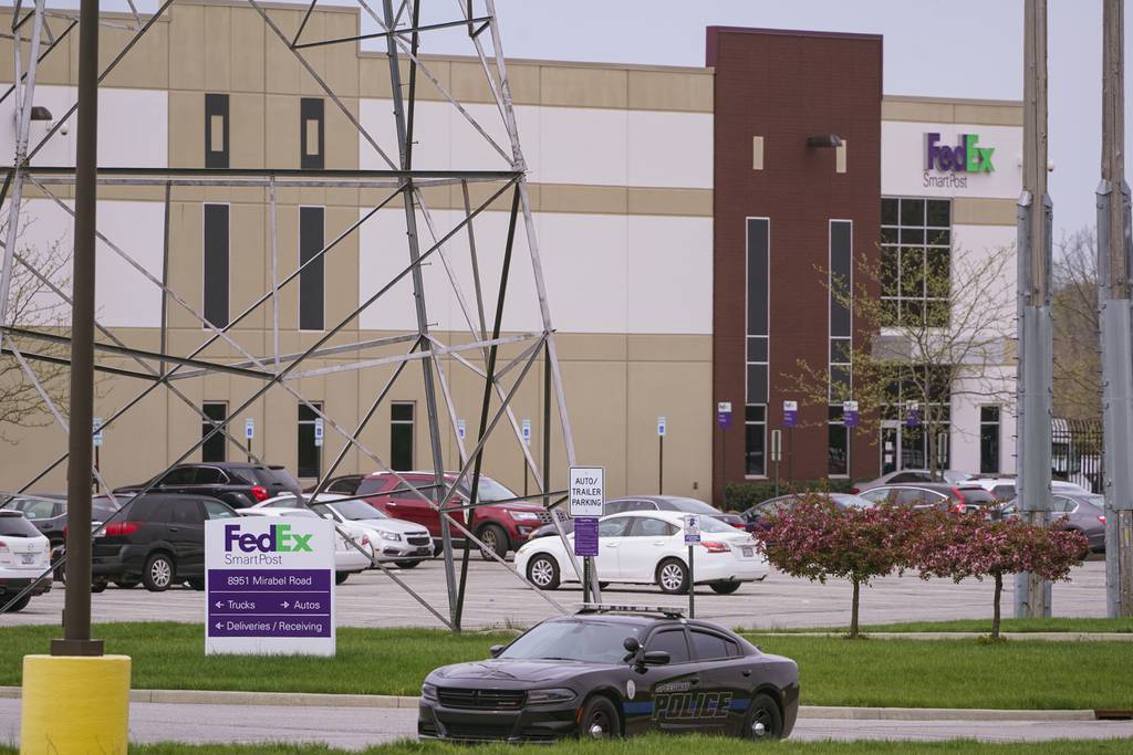 A sheriff's car blocks the entrance to the FedEx facility in Indianapolis on April 17, 2021 where eight people were killed.