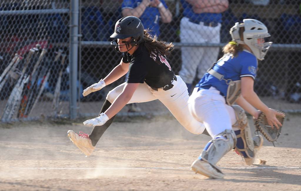 Lincoln-Way Central's Alexis Youngren (11) avoids the tag and scores against Lincoln-Way East during a SouthWest Suburban Conference crossover in Frankfort on Tuesday, April 11, 2023.