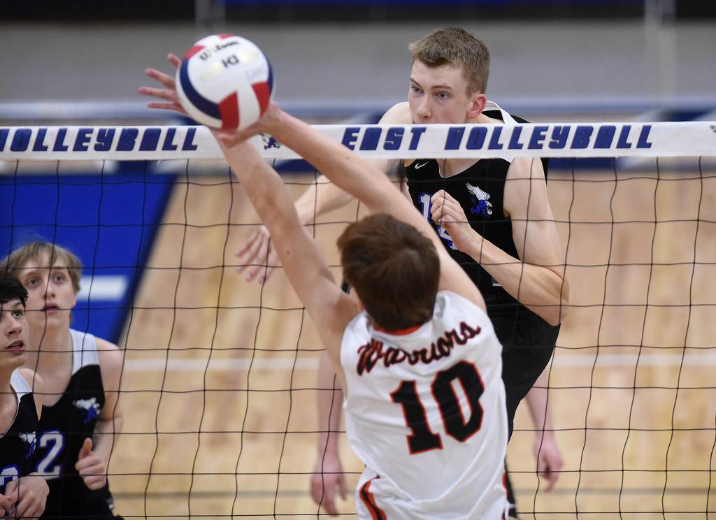 Lincoln-Way East's Joey Glennon (14) sends the ball past Lincoln-Way West's Will Pluskota (10) during a SouthWest Suburban Conference crossover in Frankfort on Thursday, April 20, 2023.