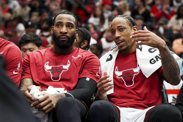 Bulls forward DeMar DeRozan, right, speaks to center Andre Drummond on the bench during the second quarter of a game against the Pistons at the United Center on April 9, 2023.