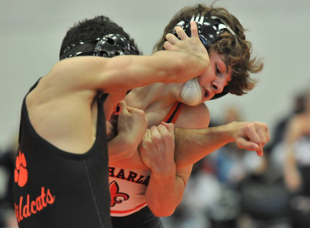 St. Charles East's Ben Davino, right, hangs onto the arm of Libertyville's Caelan Riley during a 120-pound match at the Wheaton Warrenville South Mega Duals in Wheaton on Saturday, Dec. 4, 2021.