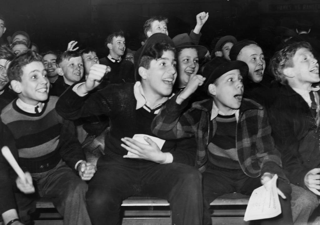 Young fans are exuberant in front of Chicago Stadium's three rings at a Golden Gloves tournament in 1940. 