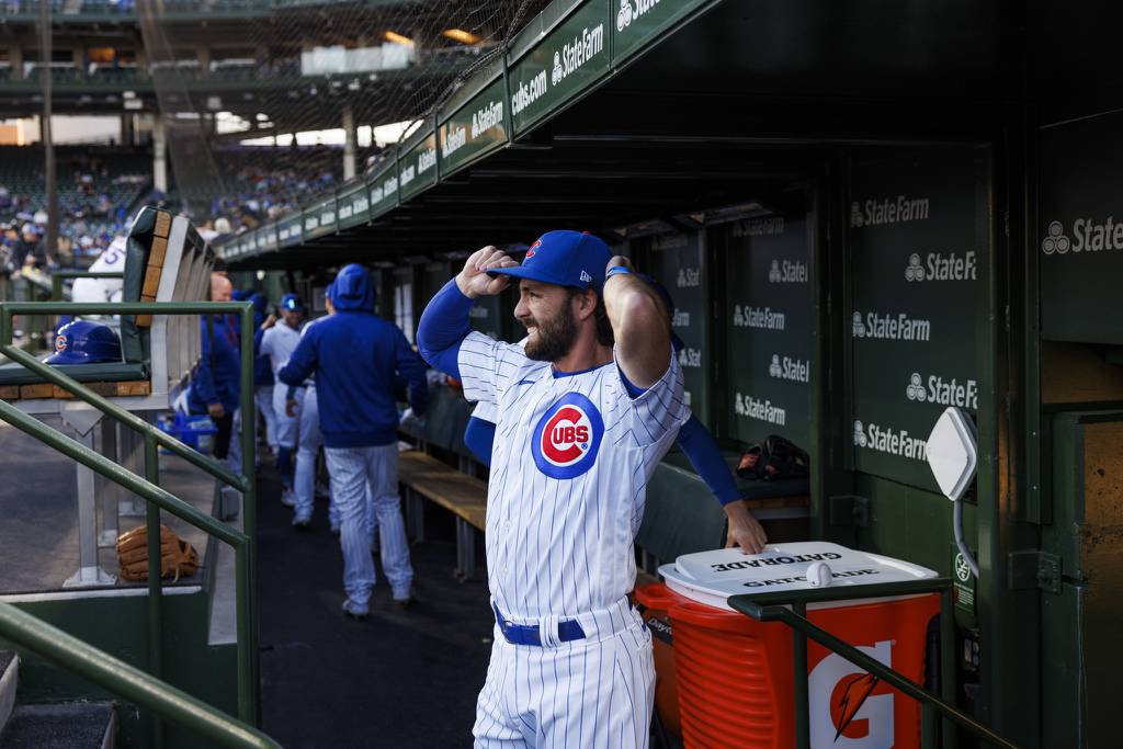 Cubs shortstop Dansby Swanson adjusts his hat in the dugout before the first inning against the Mariners at Wrigley Field on April 10, 2023.