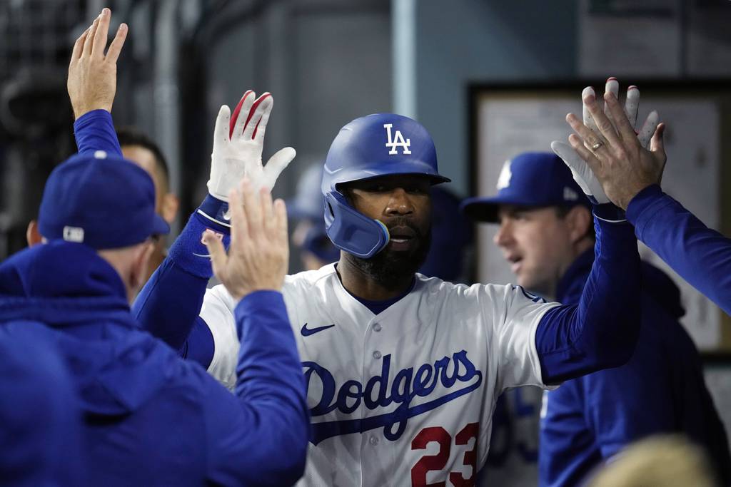 The Dodgers' Jason Heyward celebrates in the dugout after his solo home run against the Rockies on April 4, 2023, in Los Angeles.