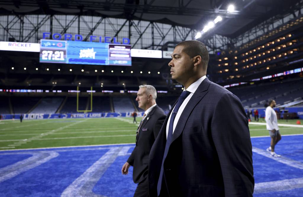 Bears general manager Ryan Poles. right, walks on the field during warmups for a game against the Lions on Jan 1. at Ford Field in Detroit.