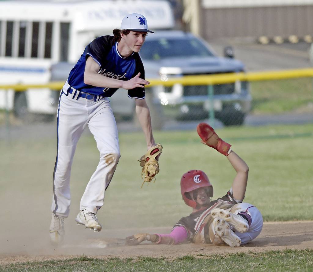 Newark's Cole Reibel, left, jumps away after tagging out Aurora Christian's Andrew Hernandez during a nonconference game in Newark on Tuesday, April 11, 2023.