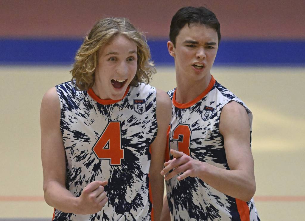 Oak Park-River Forest’s Peter Zurawski (4) and Danny McNeilly (13) celebrate a point during a match against Proviso West in Oak Park on Thursday, April 6, 2023. 