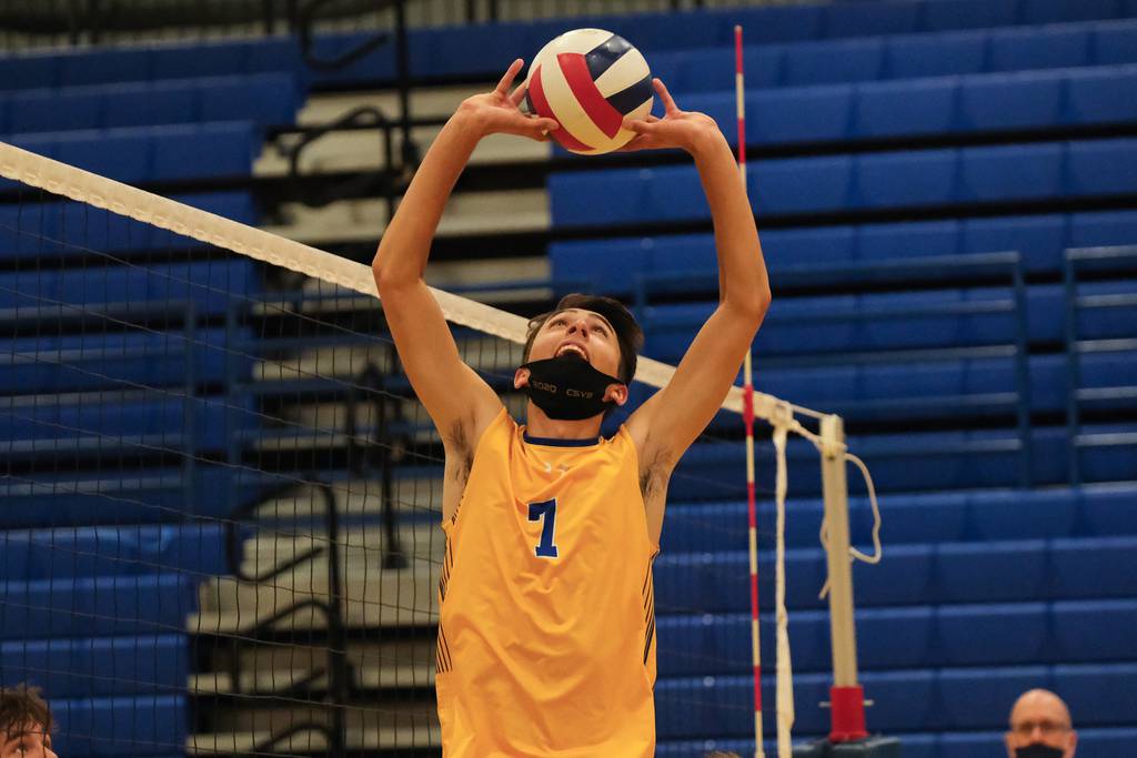 Sandburg's Jeremiah Burden sets the ball against Richards during a regional semifinal in Orland Park on Tuesday, June 8, 2021.