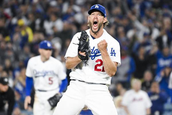 Dodgers starting pitcher Clayton Kershaw celebrates after striking out the Mets' Tommy Pham to end the seventh inning Tuesday at Dodger Stadium in Los Angeles. Kershaw tossed seven shutout innings and earned his 200th victory with the Dodgers' 5-0 win. 