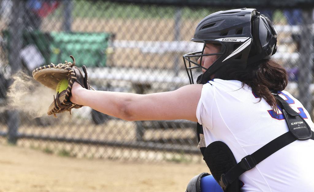 A puff of dirt pops from the glove of Larkin's Baylei Johnson as she catches a pitch against St. Edward during a Larkin Slugfest game on Saturday, April 15, 2023.