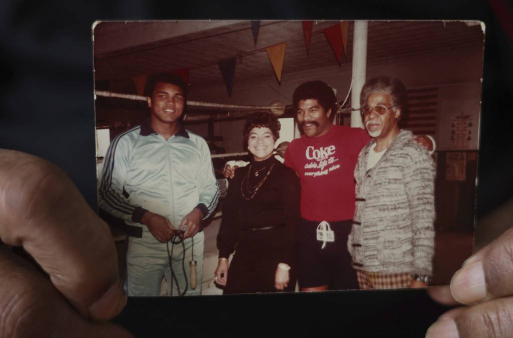 Kent Greene holds a photo taken at Windy City boxing gym in 1978. Pictured from left are: Muhammad Ali, Greene’s wife Betty Greene, Clarence Griffin and Kent Greene. The photo was taken on the same day that Ali and Greene sparred. 