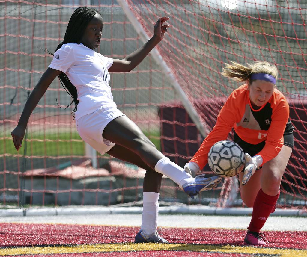 Batavia goalkeeper Natalie Dean, right, stops a shot by Neuqua Valley’s Selma Larbi during a game in Batavia on Saturday, April 8, 2023. 